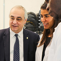 faculty photo of olevesky talking to a couple students in a lab