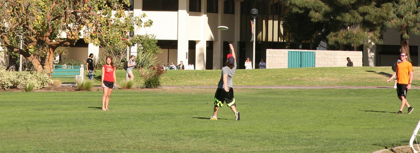 Students playing frisbee